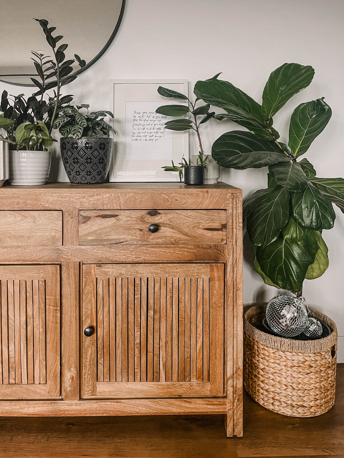 framed irish blessing on a console table surrounded by plants