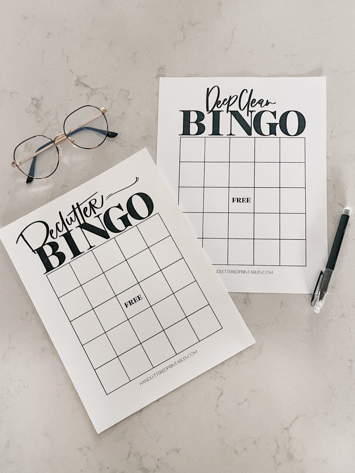 Deep clean bingo and declutter bingo printed on countertop with pen and glasses