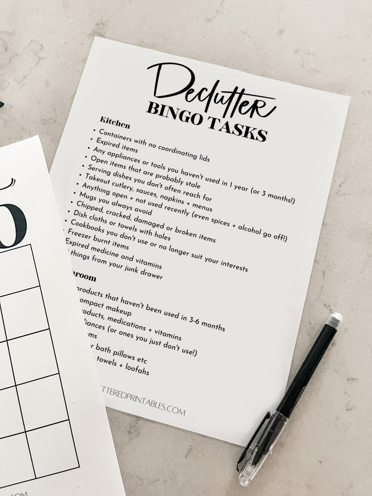 Minimalist declutter checklist printed on counter with pen