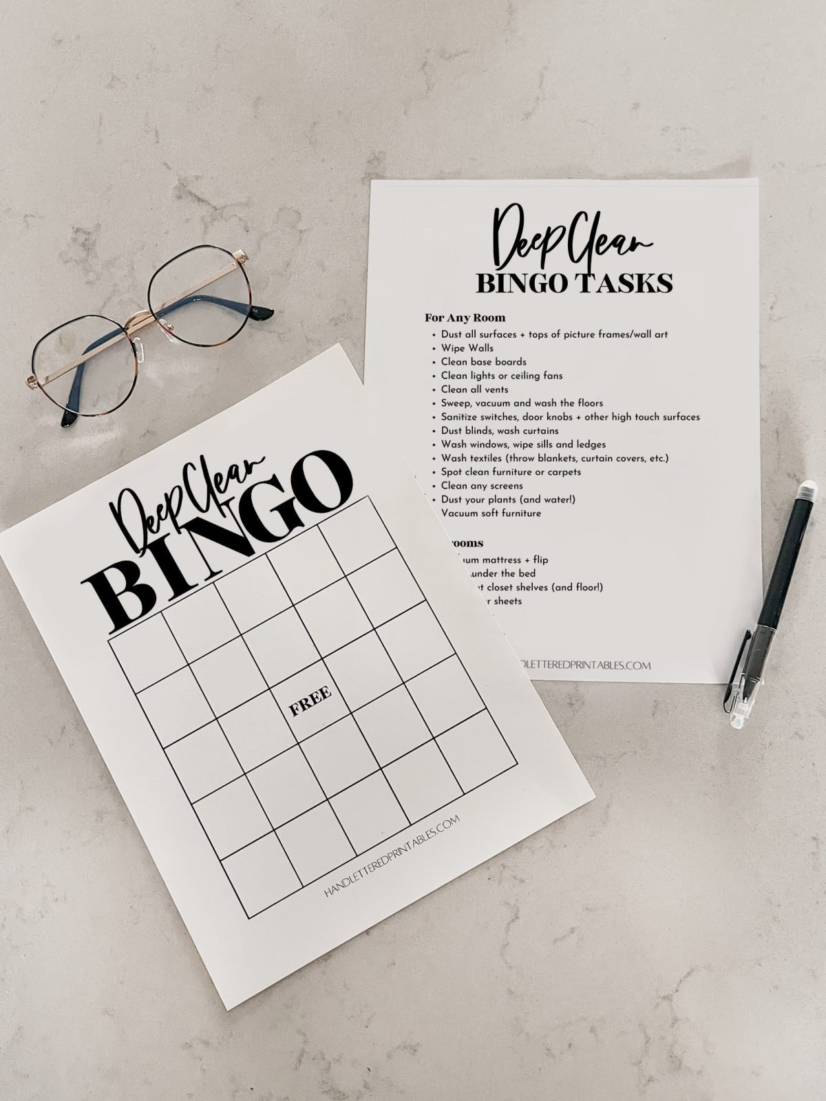 Deep Clean bingo and checklist printed on counter with pen and glasses