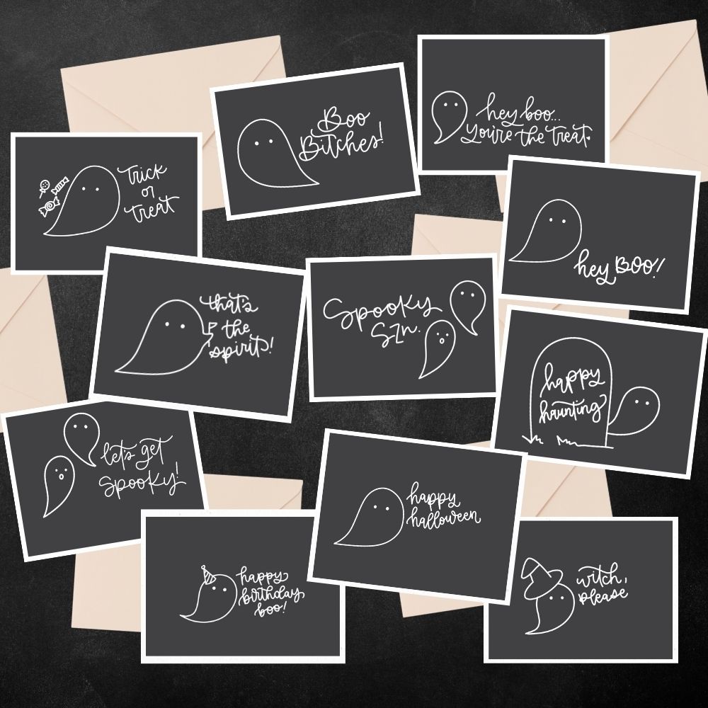 Free printable cards for halloween- shows the printed cards with natural colored envelopes. cards have a charcoal background with white line art ghosts and halloween greetings like 'happy halloween' 'happy haunting' 'let's get spooky' and more.