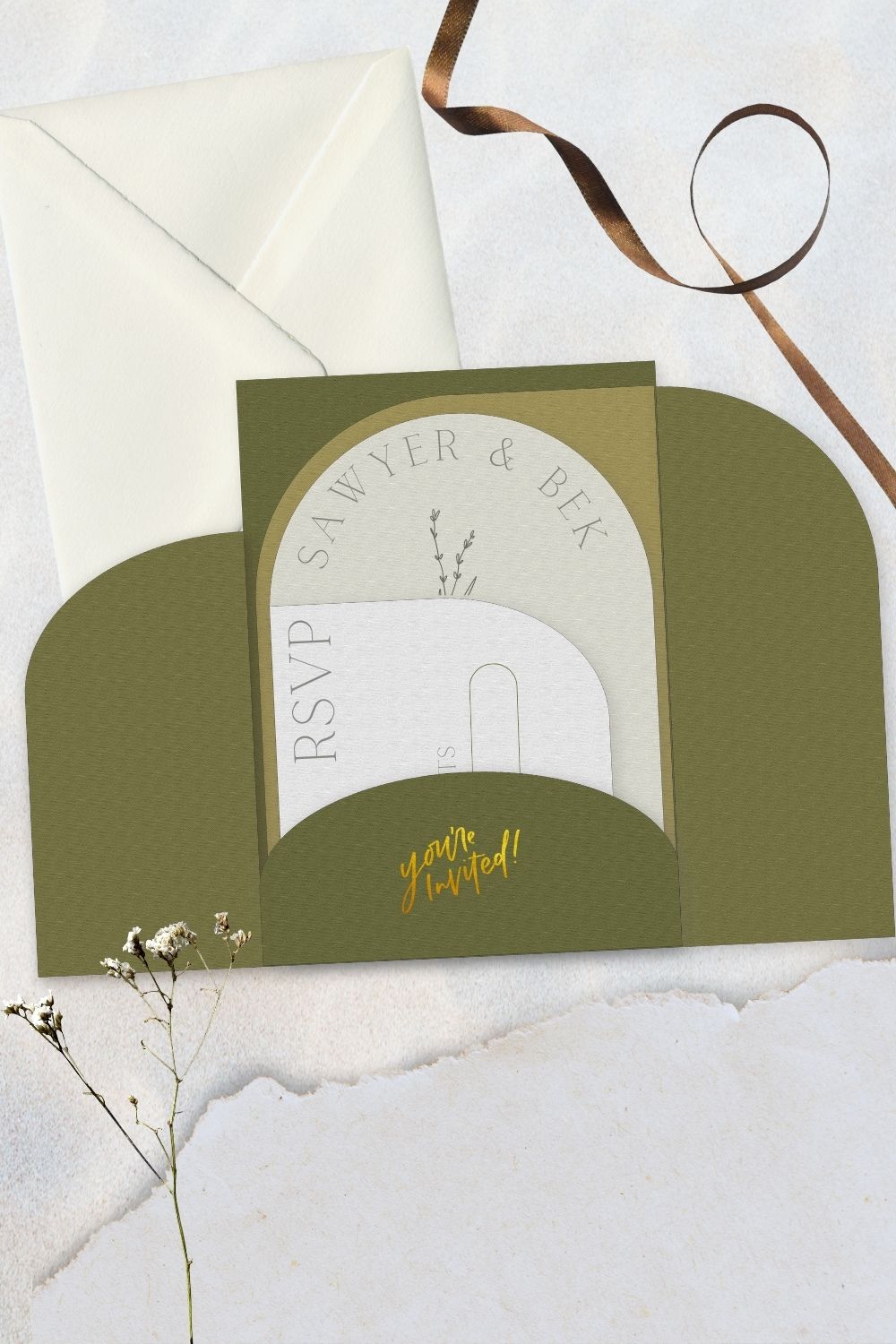 Free wedding invite template- showing the trifold arches invitation open with 'you're invited' with gold foil on pocket. rsvp card and invitation as well as information card in pocket.