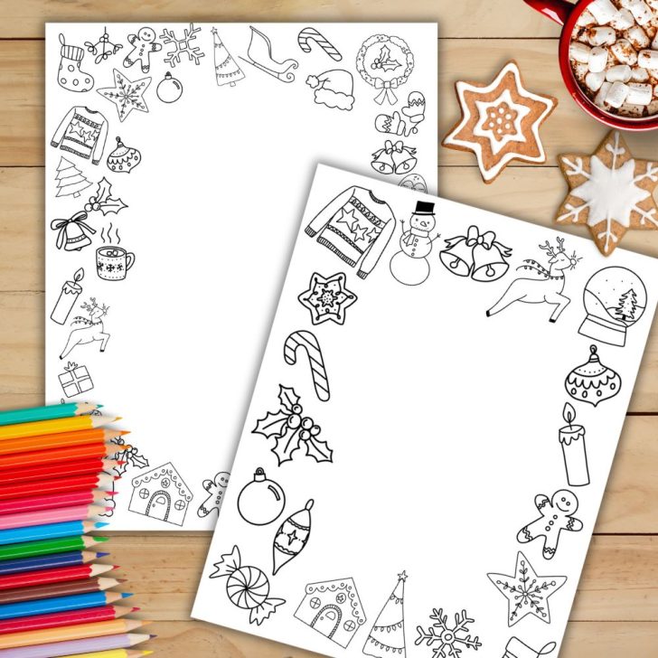 Christmas border paper printables for your holiday stationery on wood table with pencil crayons