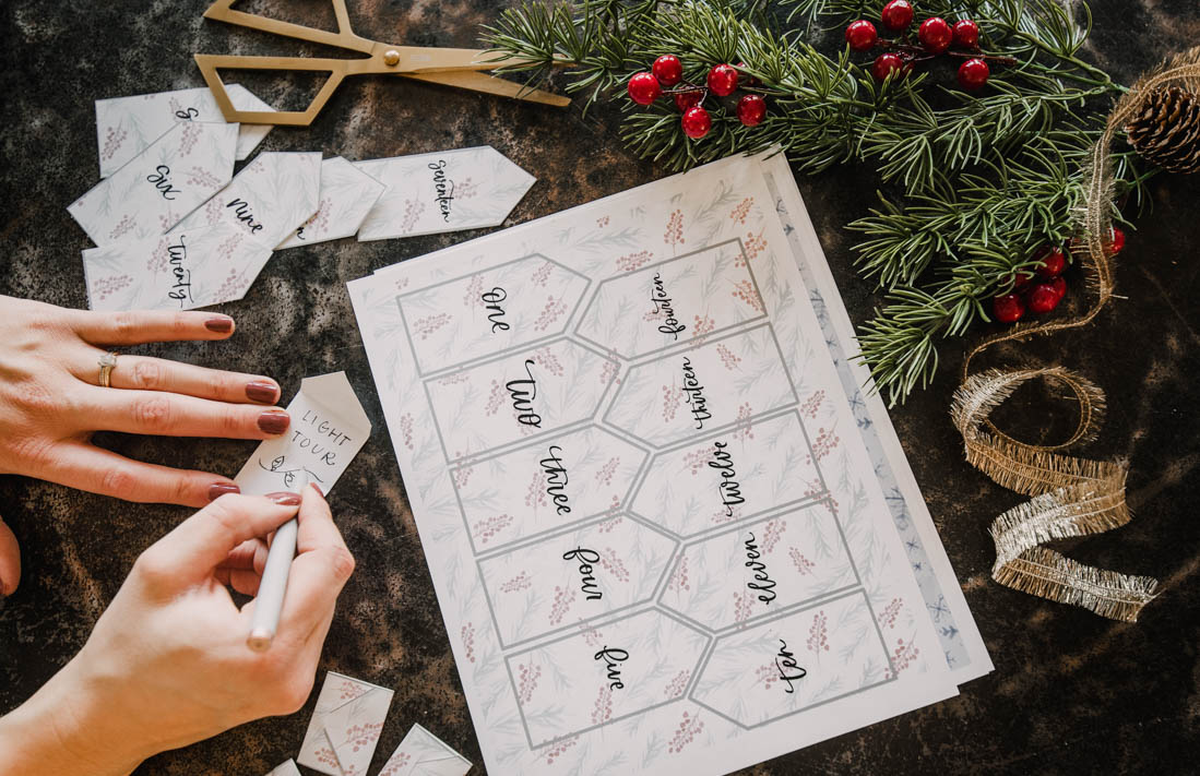 Christmas activity advent calendar craft- image shows parent writing in the activities