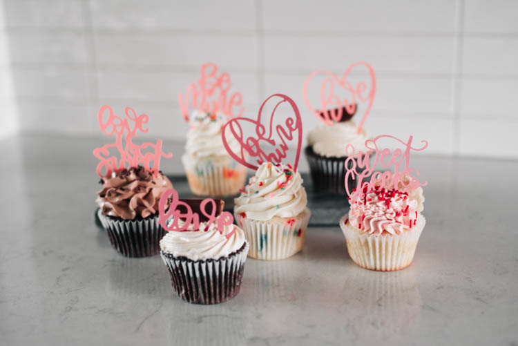 hand lettered cupcake toppers (SVG files) for valentines day, image of finished card stock cupcake toppers in cupcakes