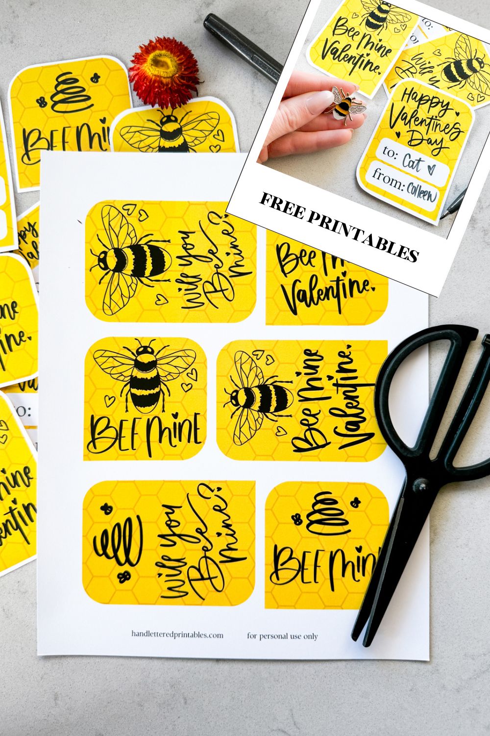 image of printed bee themed valentines cards on marble counter, all ready to be cut out. valentines cards read: bee mine, will you bee mine, and bee mine valentine with illustrations of a bee and of a line art bee hive. reverse has space for names and says 'happy valentines day'. all hand lettered in black ink with yellow honeycomb background image overlay reads 'free printables'