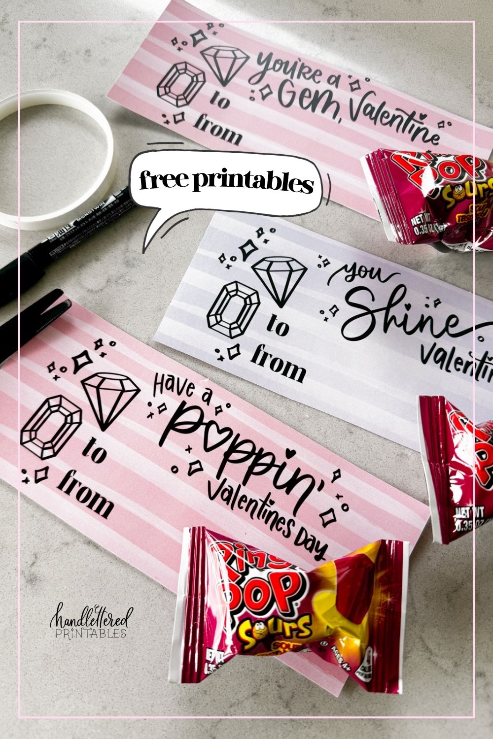 image of printed valentines with a gem theme, designed to pair with ring pops. printed and cut to size on a marble counter shown with ring pops in packaging for each valentine card hand lettered valentines in both pink and purple read:' you're a gem, valentine', 'you shine, valentine', and 'have a poppin' valentine's day' image overlay reads 'free printables'