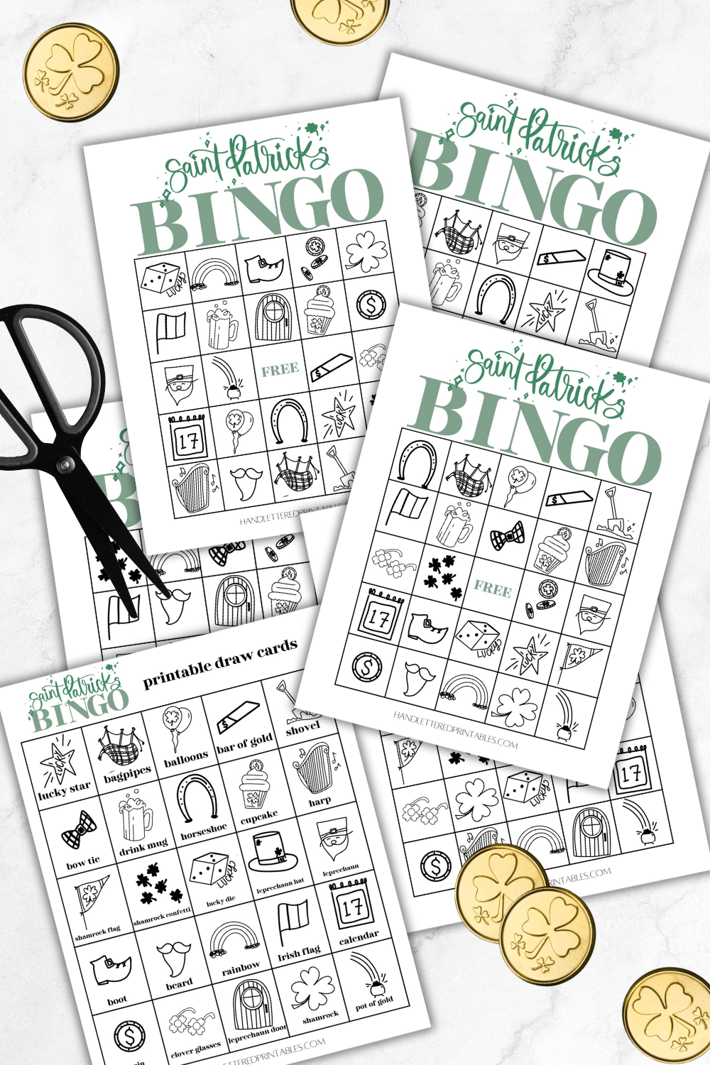 image of three printed saint patrick's day bingo cards with 1 printed saint patricks day bingo calling cards ready to be cut out on marble counter styled with black scissors and plastic gold coins