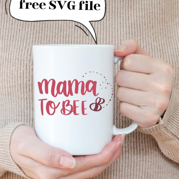 Free SVG file in text bubble above mug with 'mama to bee' hand lettered SVG design applied to mug- design features a hand drawn bee. mug being held by woman's hand