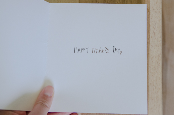 inside of father's day card being shown, held by woman's hand reads: happy father's day (free printable card)