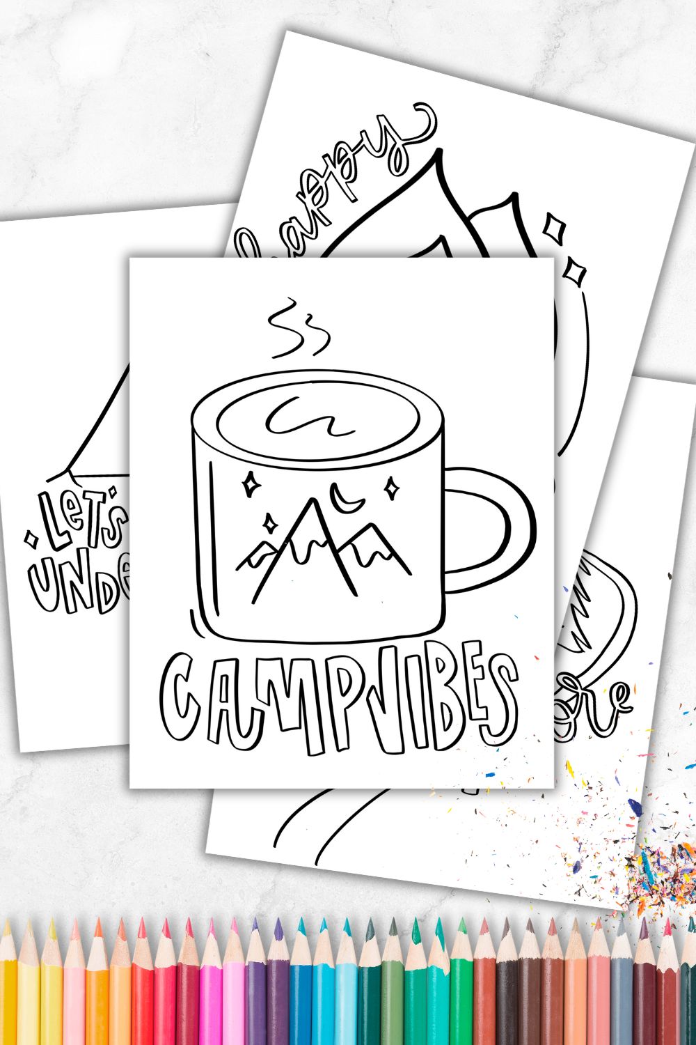 4 camping coloring sheets on marble countertop with pencil crayons. Coloring sheets designed with chunky brush lettering style with hand lettered phrases like 'camp vibes', 'happy camper' 'let's sleep under the stars' and 'let's explore' with line illustrations ready for coloring of a camp mug, campfire, tent under the night sky and trees with hiking trail.