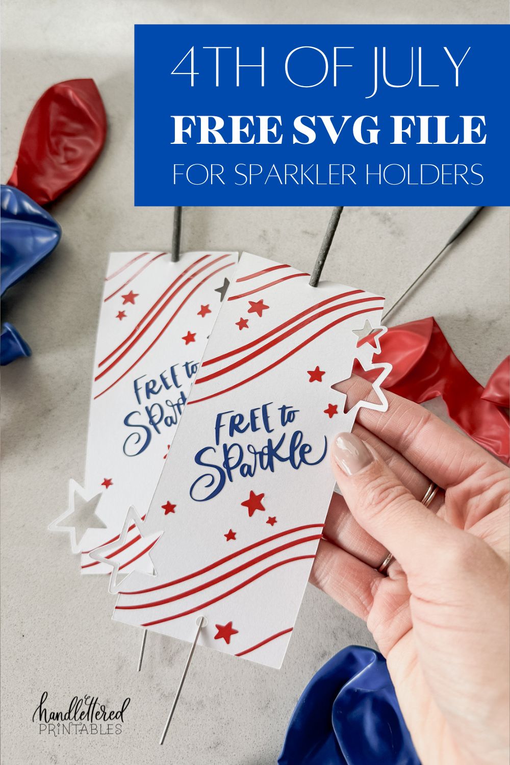 image of fourth of july sparklers holders free svg file with 3 layers, shown assembled with sparklers, being held by hand above a countertop with red and blue balloons text over reads: 4th of july free svg file for sparkler holders