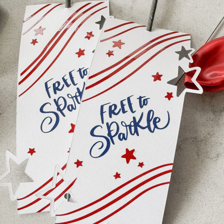 image of fourth of july sparklers holders free svg file with 3 layers, shown assembled with sparklers, on a countertop with red and blue balloons
