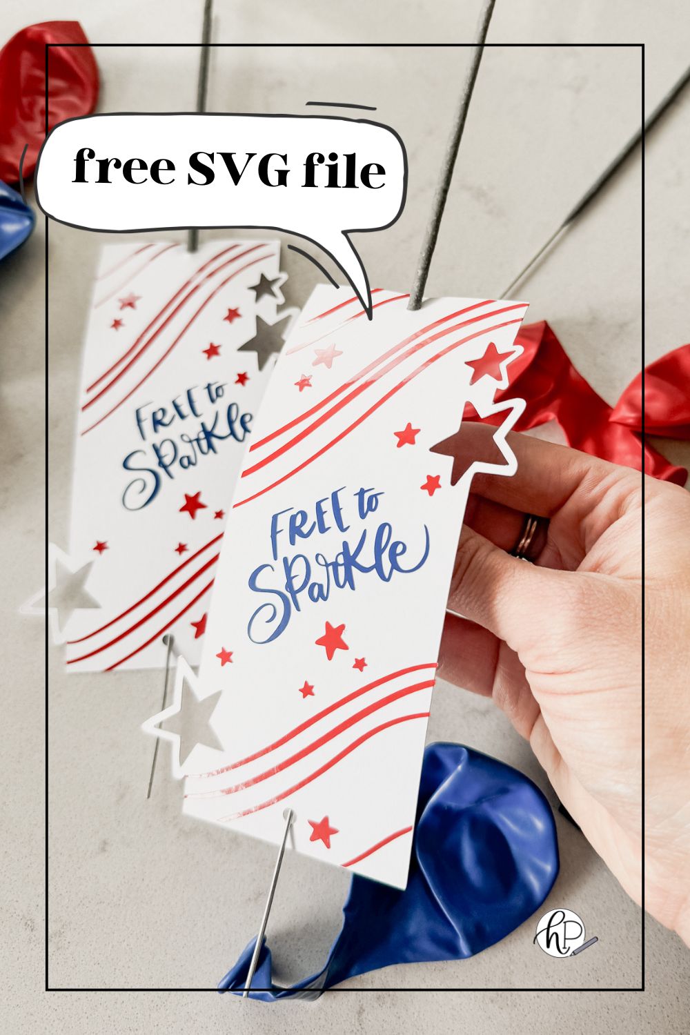 image of fourth of july sparklers holders free svg file with 3 layers, shown assembled with sparklers, being held by hand above a countertop with red and blue balloons text over reads: free svg file